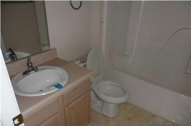 full bathroom with vanity, bathtub / shower combination, and toilet