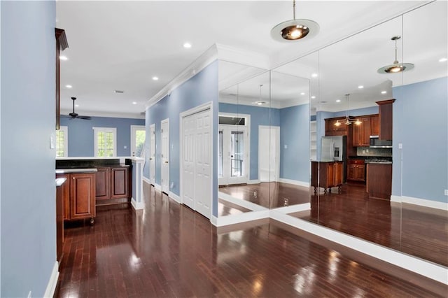 101 Fairhope Ct N Unit 16, Fairhope, AL 36532 - kitchen with appliances with stainless steel finishes, baseboards, dark wood-type flooring, dark countertops, and crown molding