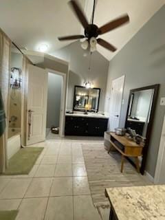bathroom featuring a ceiling fan, vaulted ceiling, bathtub / shower combination, tile patterned floors, and vanity