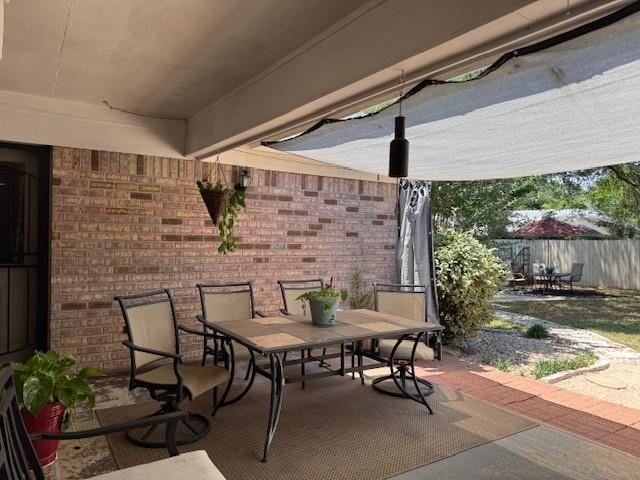 view of patio / terrace featuring fence and outdoor dining area
