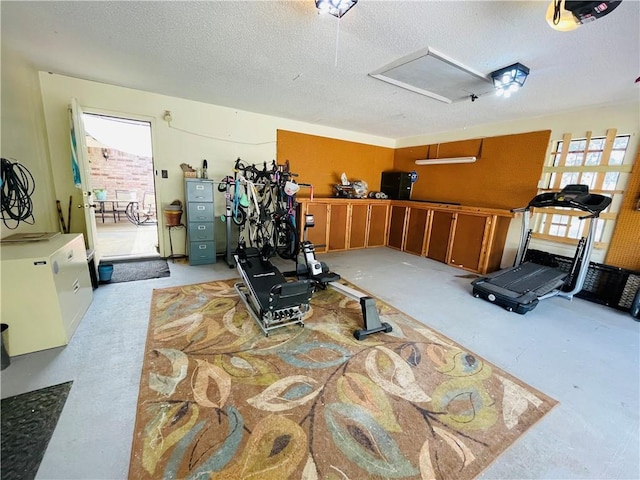 exercise room featuring plenty of natural light and a textured ceiling