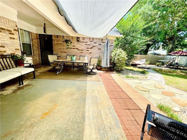 view of patio featuring fence and outdoor dining space