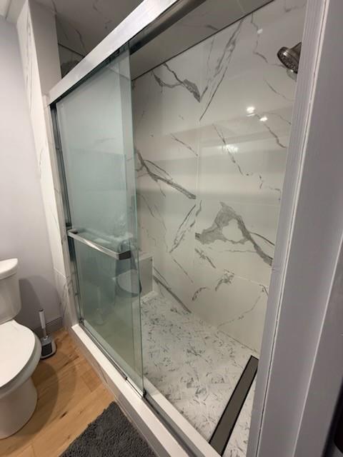 1071 Coke Ct, Mobile, AL 36695 - bathroom with a marble finish shower and wood finished floors