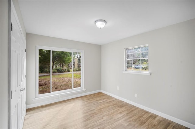 unfurnished room with a healthy amount of sunlight and light wood-type flooring