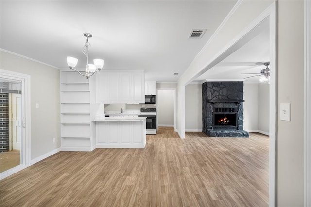 unfurnished living room with a fireplace, light wood-type flooring, ceiling fan with notable chandelier, and crown molding