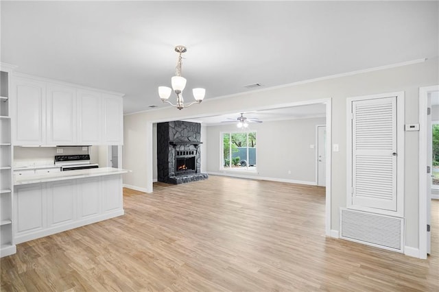 unfurnished living room with ornamental molding, ceiling fan with notable chandelier, light hardwood / wood-style floors, and a fireplace