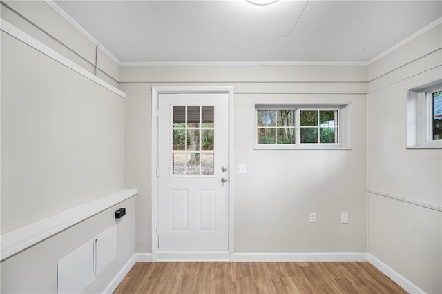 entryway featuring ornamental molding and wood-type flooring