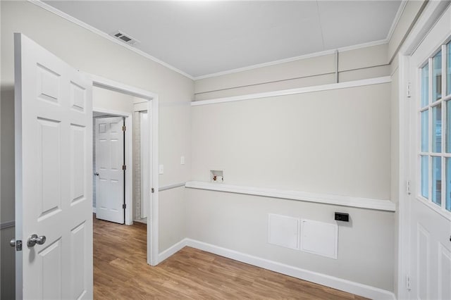 hall with hardwood / wood-style flooring, a healthy amount of sunlight, and crown molding