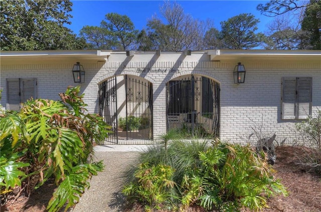 entrance to property featuring brick siding