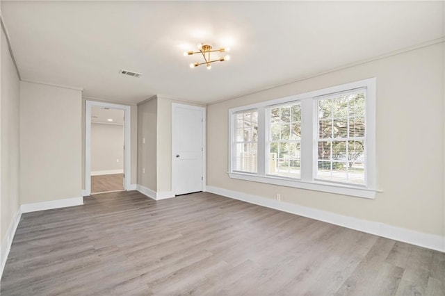 empty room with a chandelier and hardwood / wood-style floors