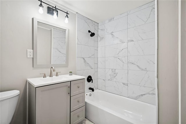 full bathroom featuring toilet, vanity, and tiled shower / bath