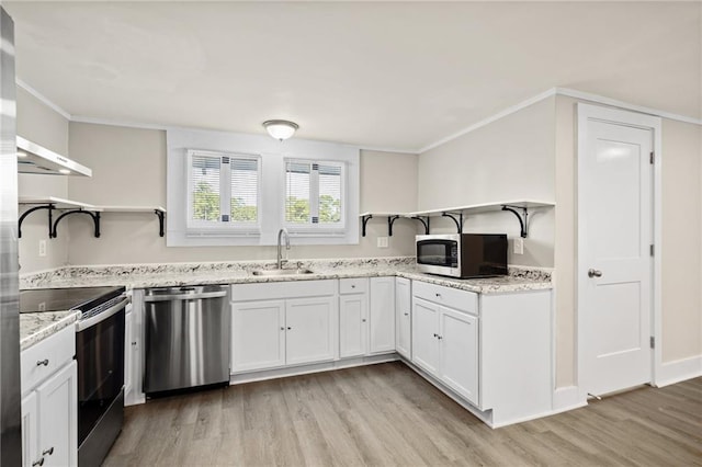 kitchen with stainless steel appliances, light wood-type flooring, white cabinets, light stone counters, and sink