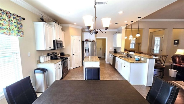 1109 Orlando Dr, Foley, AL 36535 - kitchen with stainless steel appliances, a chandelier, a sink, crown molding, and white cabinetry