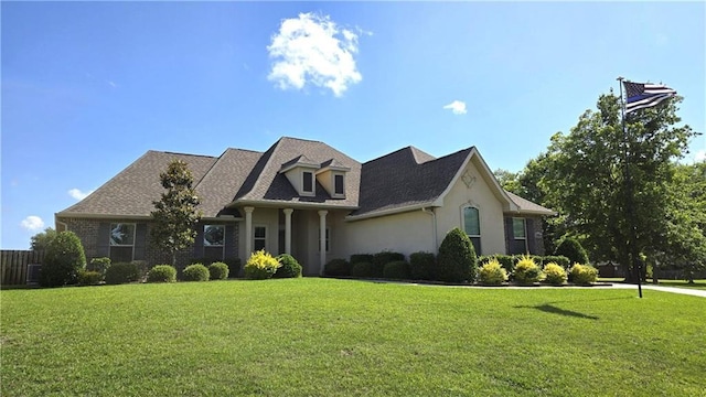 1109 Orlando Dr, Foley, AL 36535 - view of front facade with a front lawn, stucco siding, and roof with shingles