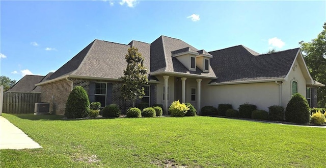 1109 Orlando Dr, Foley, AL 36535 - cape cod-style house featuring stucco siding, a shingled roof, and central air condition unit