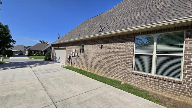 1109 Orlando Dr, Foley, AL 36535 - view of home's exterior featuring concrete driveway, a shingled roof, a garage, and brick siding