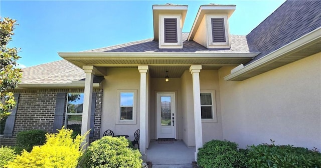 1109 Orlando Dr, Foley, AL 36535 - doorway to property with stucco siding and a shingled roof