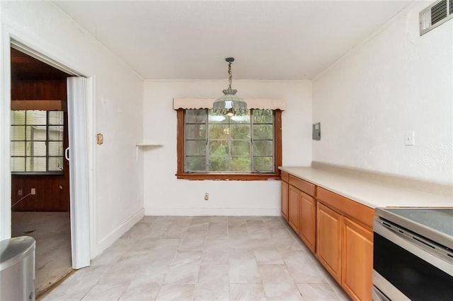 kitchen featuring an inviting chandelier, decorative light fixtures, and stainless steel range with electric cooktop