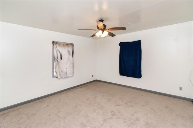 empty room featuring light carpet and ceiling fan