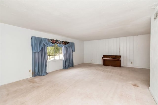 unfurnished room featuring light colored carpet