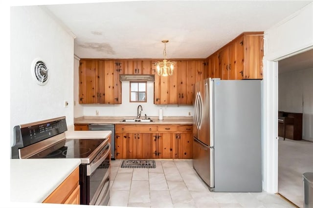 kitchen with pendant lighting, appliances with stainless steel finishes, a chandelier, and sink