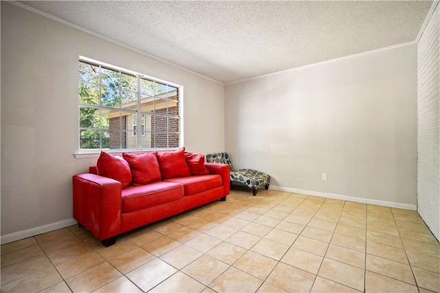 living area with ornamental molding, a textured ceiling, and light tile patterned flooring