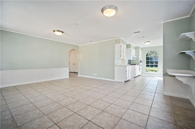 unfurnished living room featuring crown molding and light tile patterned floors