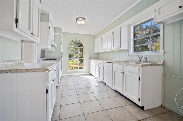 kitchen with white cabinetry, white appliances, and light tile patterned floors