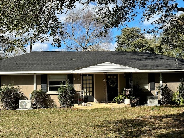 rear view of house featuring a lawn