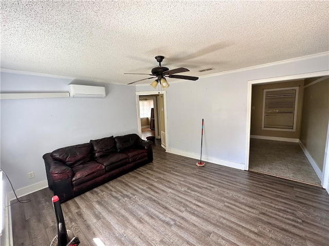 tiled living room featuring a wall mounted air conditioner, a textured ceiling, and ceiling fan