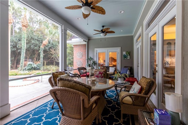 sunroom / solarium featuring french doors and a ceiling fan