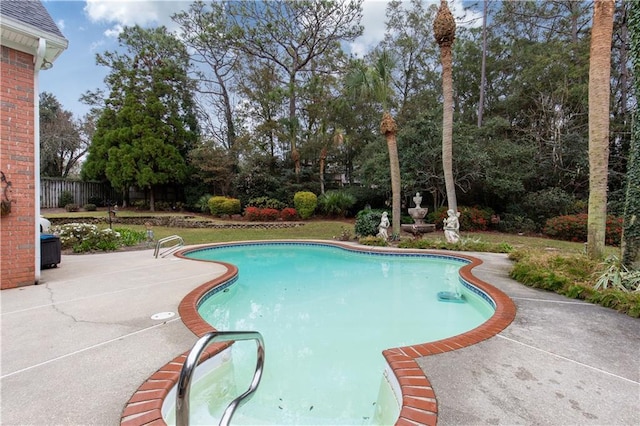 view of swimming pool featuring a patio area and fence