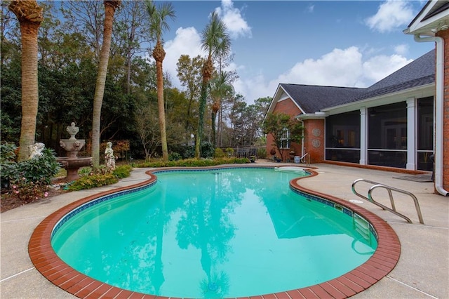 pool featuring a patio area and a sunroom