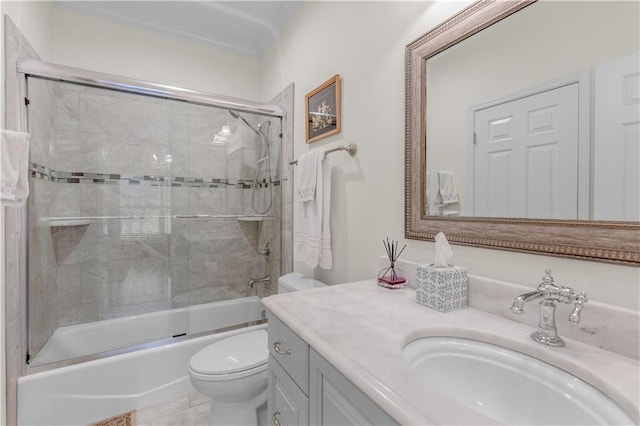 bathroom featuring vanity, toilet, crown molding, and shower / bath combination with glass door