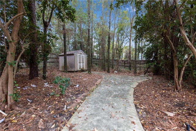 view of yard featuring an outbuilding, a shed, and a fenced backyard