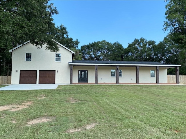 back of house featuring a yard and a garage