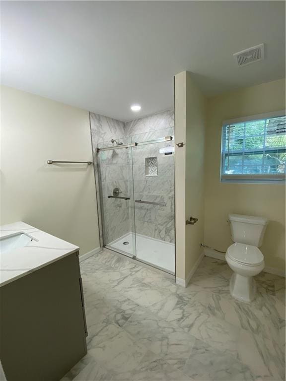 bathroom featuring tile patterned floors, toilet, a shower with shower door, and vanity