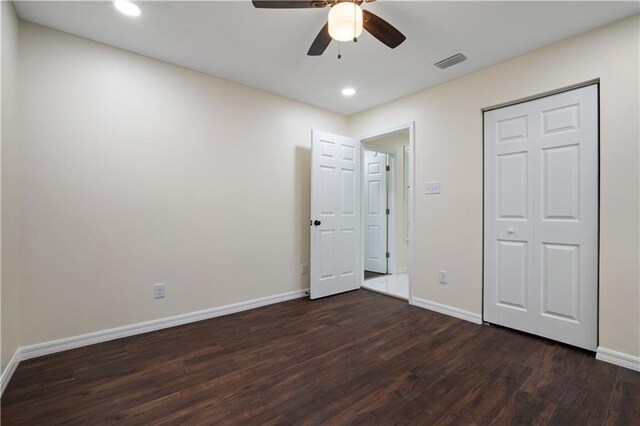 bathroom featuring tile patterned flooring, a shower with shower door, vanity, and toilet