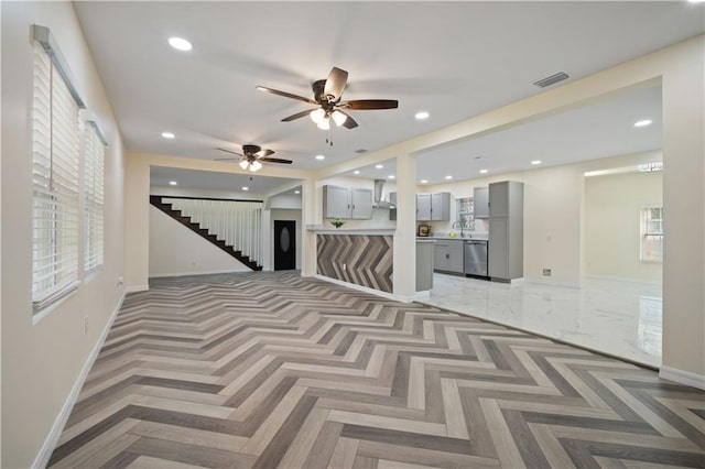 unfurnished room with stairway, recessed lighting, visible vents, and a sink