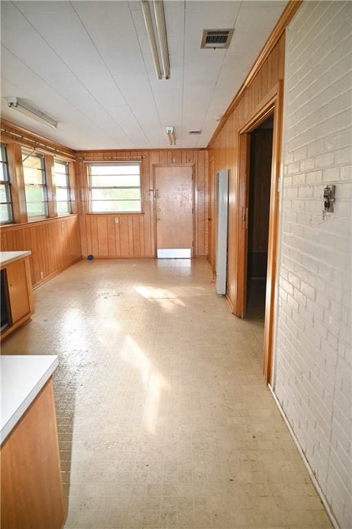 interior space with wooden walls and brick wall