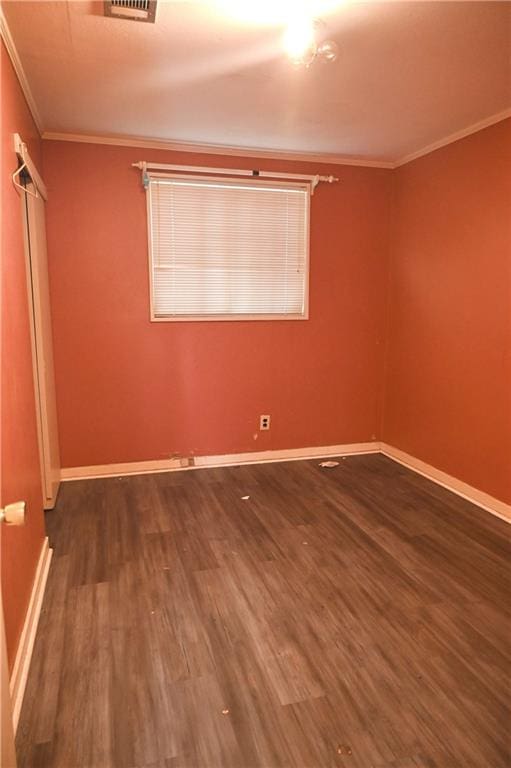 unfurnished bedroom featuring dark hardwood / wood-style floors and crown molding