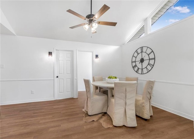 dining room with vaulted ceiling, wood finished floors, baseboards, and ceiling fan