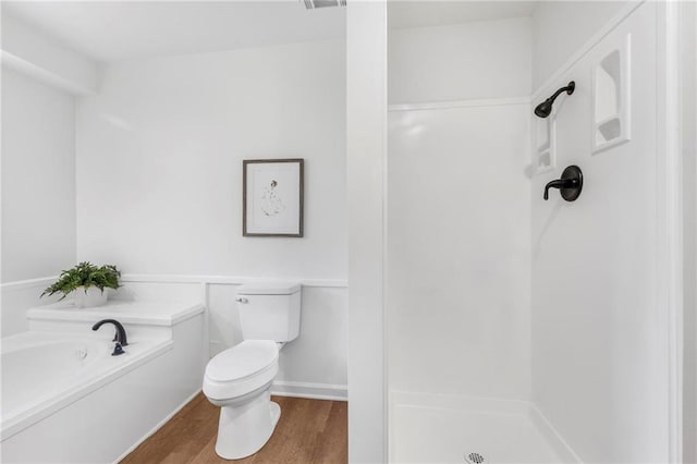 full bathroom with visible vents, toilet, a stall shower, wood finished floors, and a bath