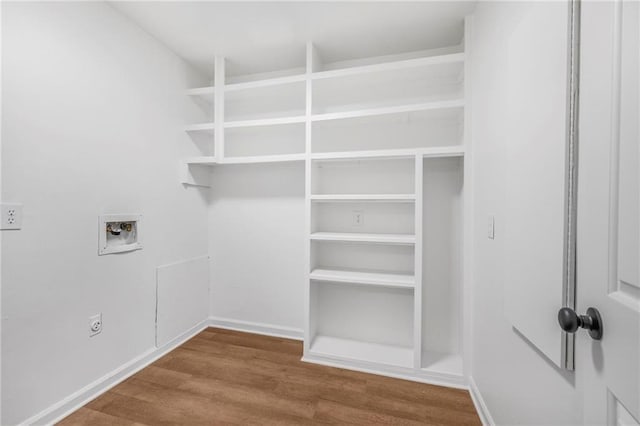 laundry room featuring hookup for a washing machine, wood finished floors, baseboards, laundry area, and electric dryer hookup