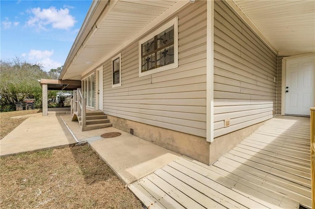 view of property exterior with entry steps and a patio area