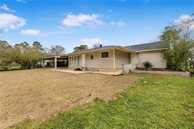 back of property with a patio area and a lawn