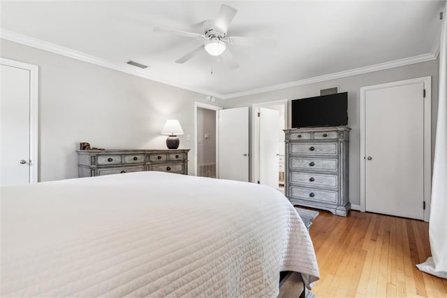 bedroom with hardwood / wood-style flooring, ornamental molding, and ceiling fan