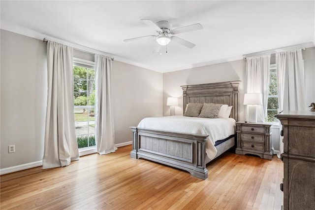 bedroom with ornamental molding, light hardwood / wood-style floors, and ceiling fan