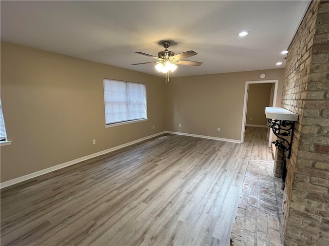 unfurnished living room with ceiling fan and hardwood / wood-style floors