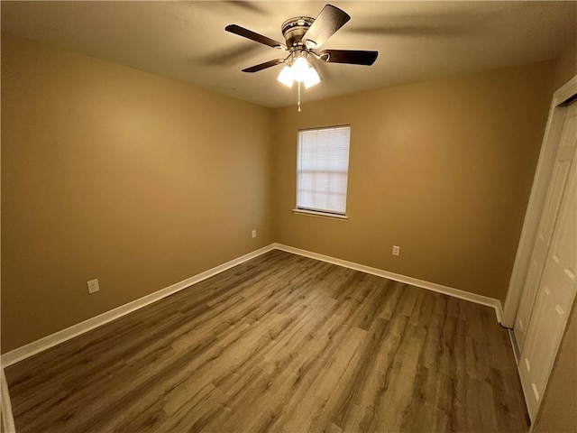 empty room with hardwood / wood-style floors and ceiling fan